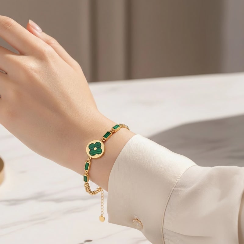 An elegant gold bracelet made of rust-resistant stainless steel, featuring a large, distinctive green flower at its center, adorned with green stones. It has an adjustable clasp for a perfect fit. - Image 3